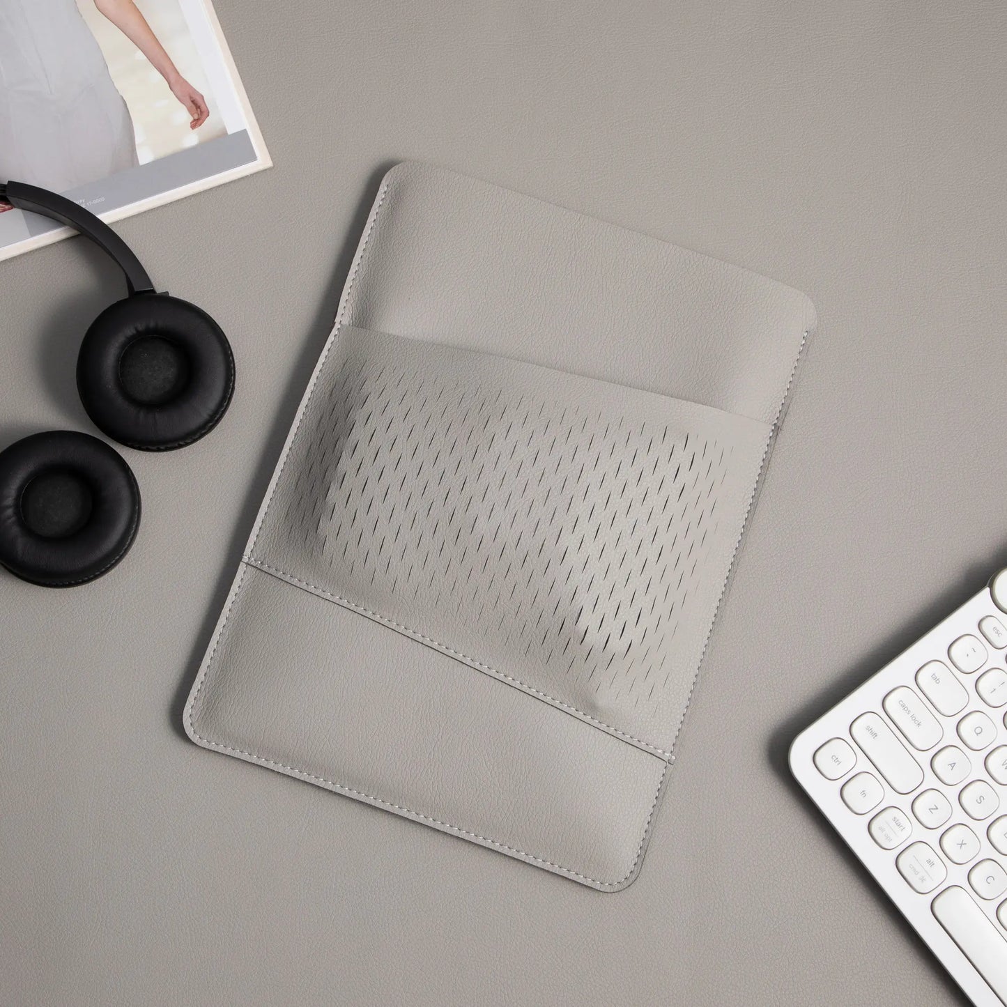 Detail of honeycomb storage pouch on 2-in-1 slim leather MacBook sleeve - light gray.