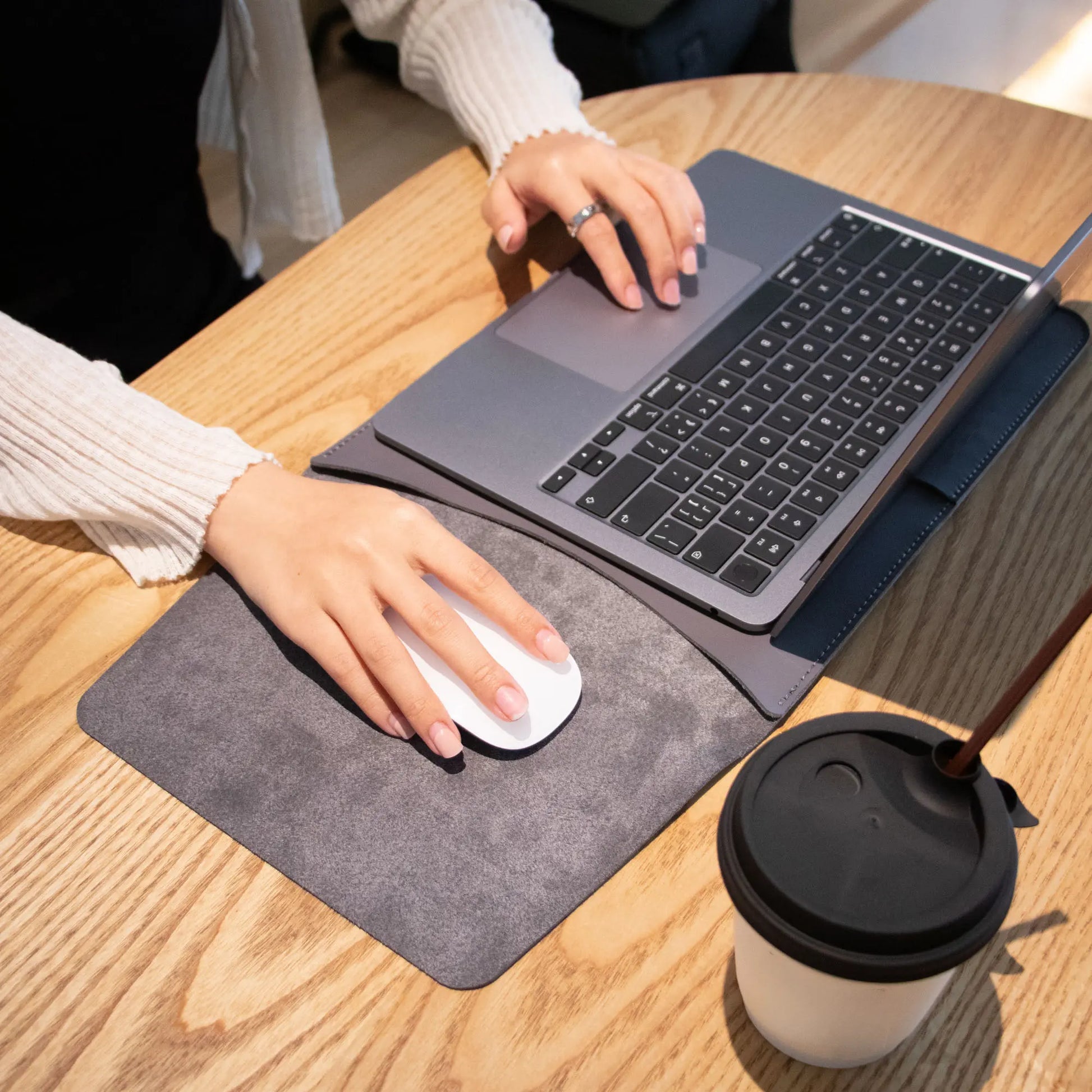 Lifestyle shot of antibacterial 3-in-1 vintage gray MacBook leather sleeve.