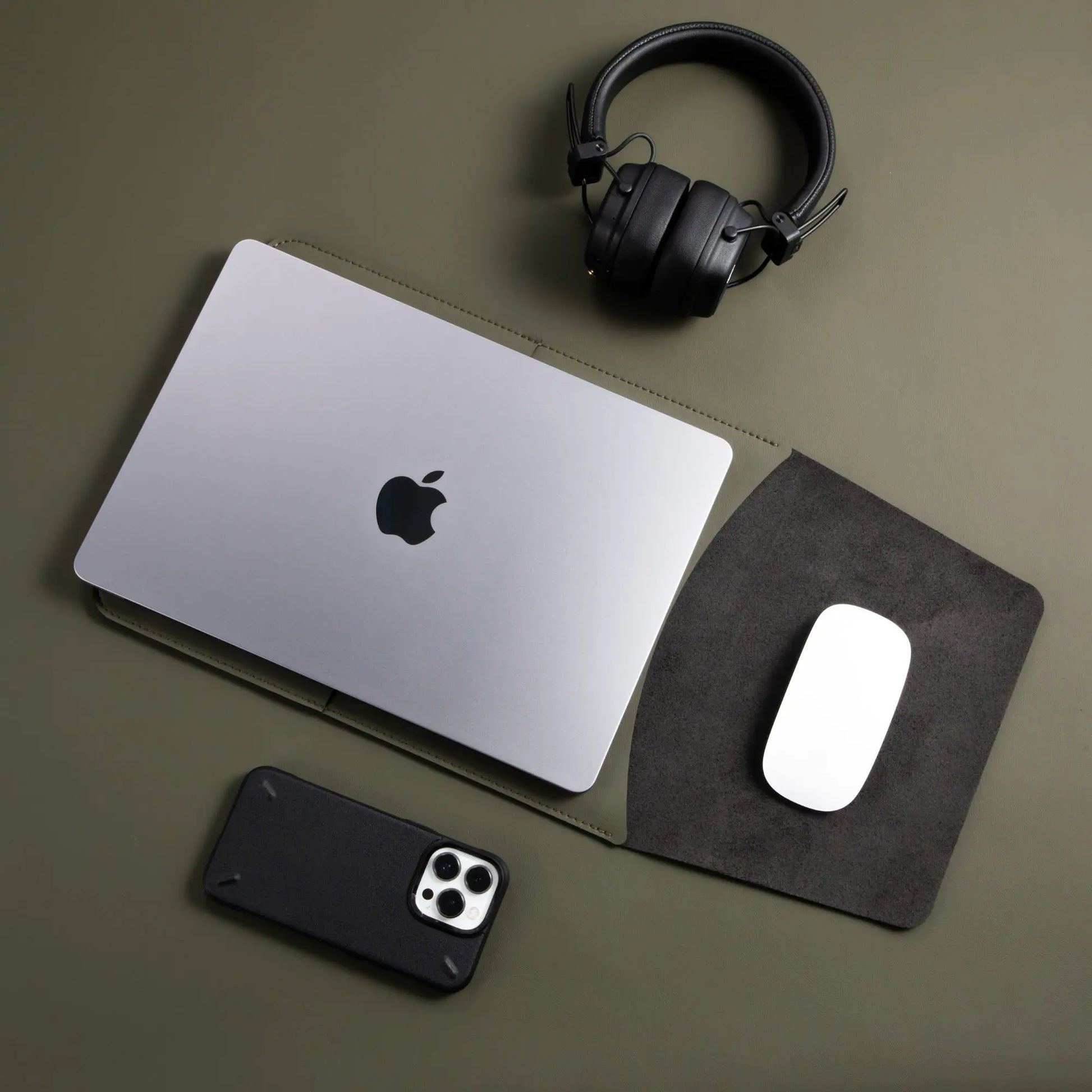 Usage view of antibacterial 3-in-1 olive green MacBook leather sleeve with MacBook and Magic Mouse.