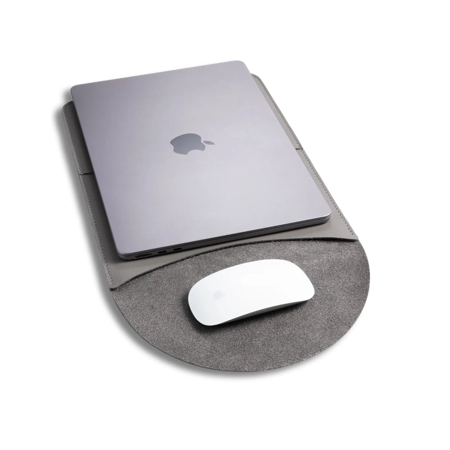 Closeup view of slim 3-in-1 MacBook sleeve usage, with built-in round mouse pad - dark gray.