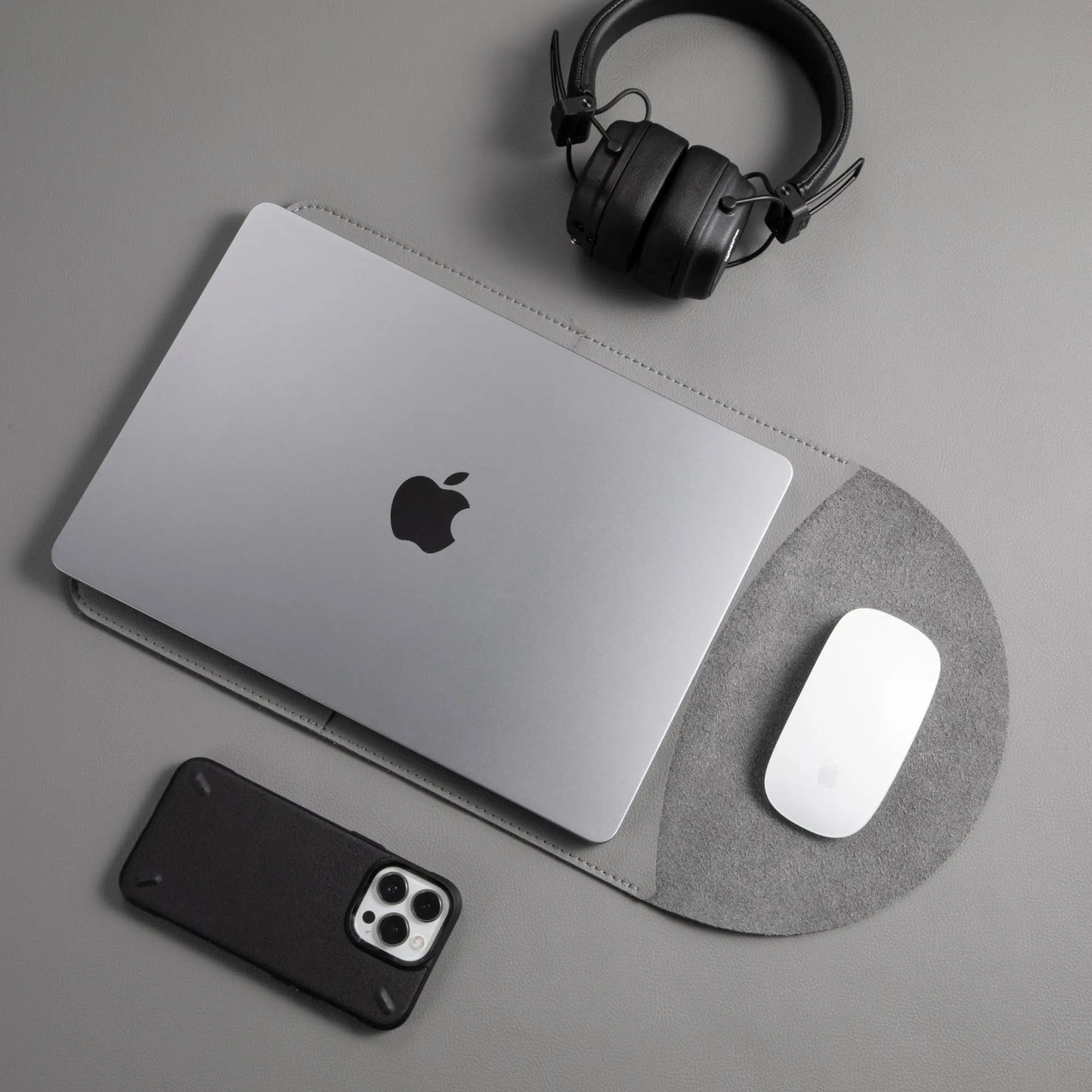 Slim 3-in-1 MacBook leather sleeve with built-in round mouse pad in use - dark gray.