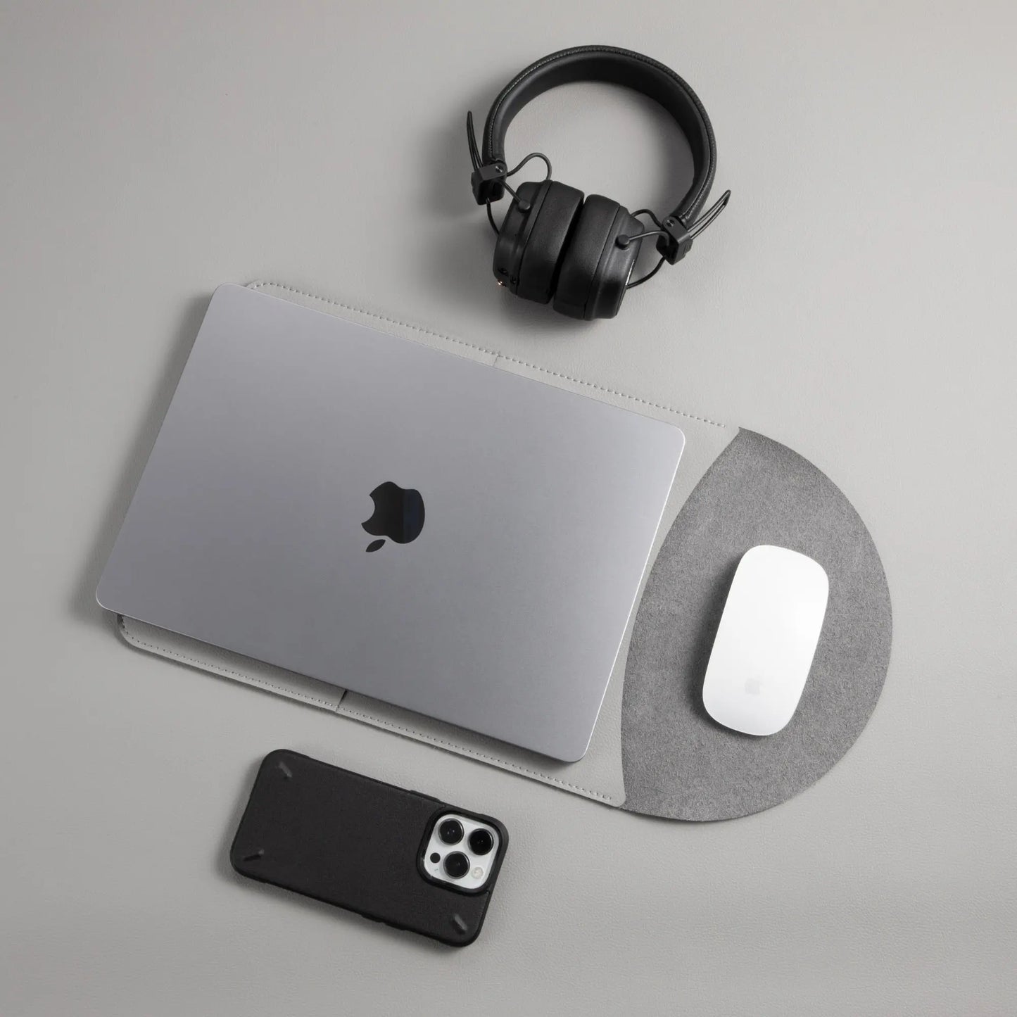 Slim 3-in-1 MacBook leather sleeve with built-in round mouse pad in use - light gray.