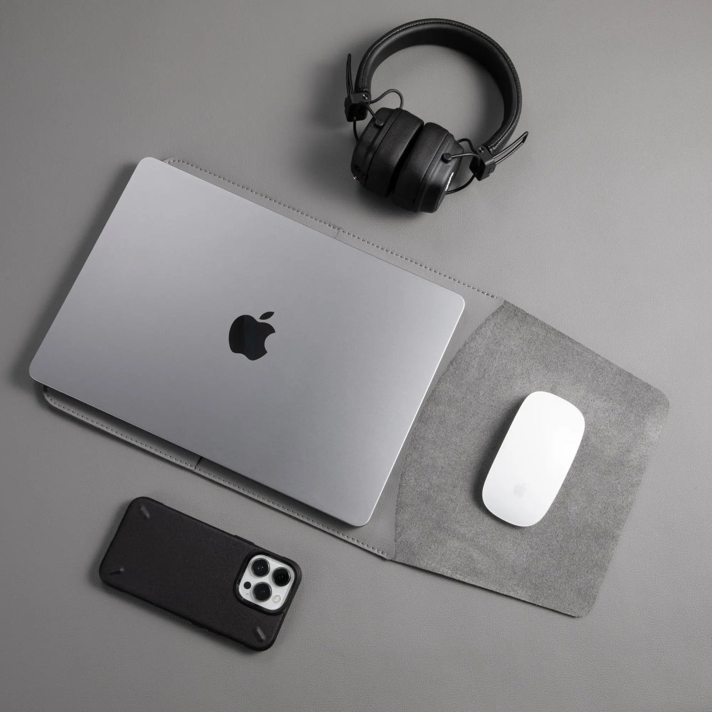 Slim 3-in-1 MacBook sleeve with built-in square mouse pad in use - dark gray.